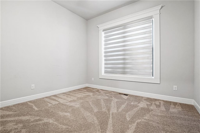 empty room with carpet floors and a healthy amount of sunlight