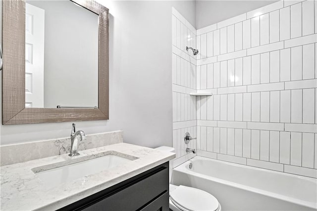 full bathroom with toilet, tiled shower / bath, and vanity