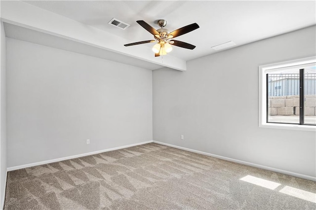 carpeted spare room featuring ceiling fan