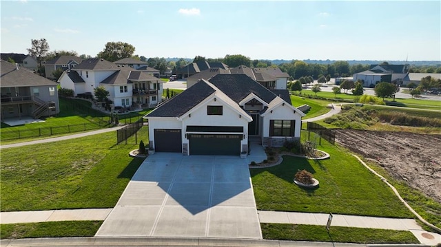 view of front of home with a front yard and a garage