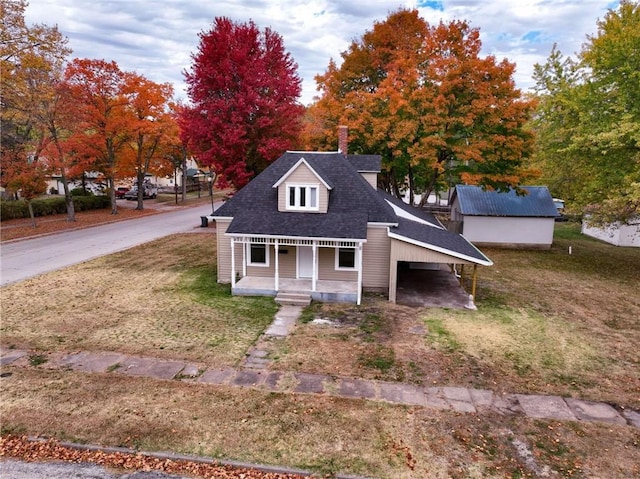 cape cod house featuring covered porch and a front yard