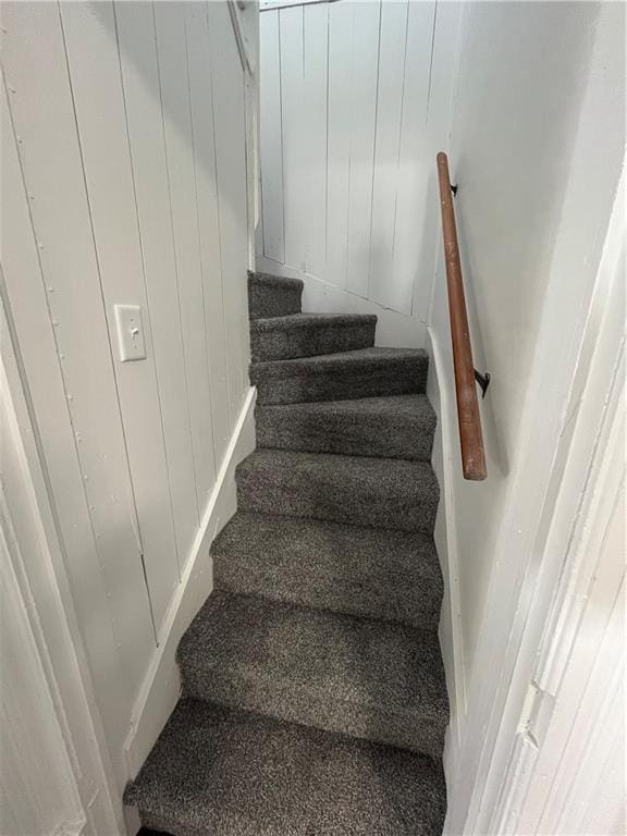 stairs with wood walls