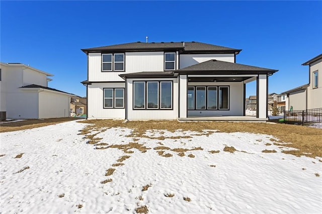 snow covered property with a patio