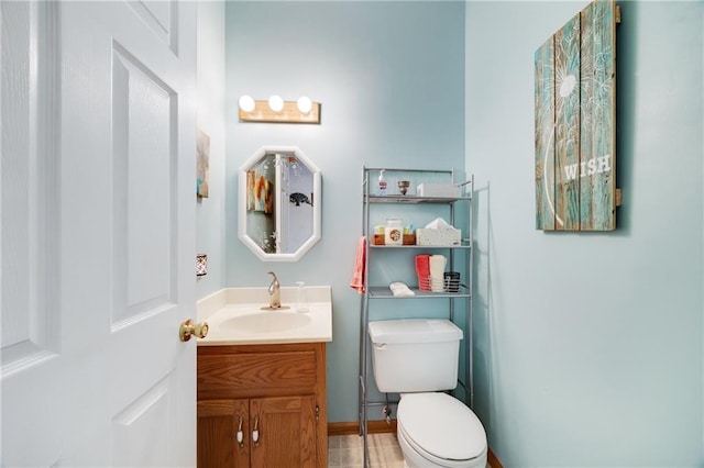 bathroom featuring vanity and toilet