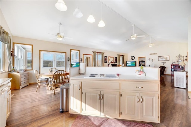 kitchen with hardwood / wood-style flooring, white appliances, vaulted ceiling, and hanging light fixtures