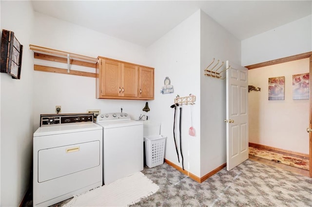 clothes washing area with cabinets, separate washer and dryer, and light colored carpet