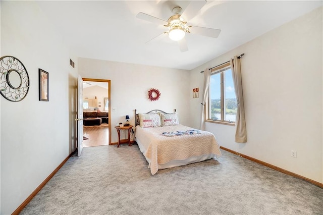 carpeted bedroom with ceiling fan