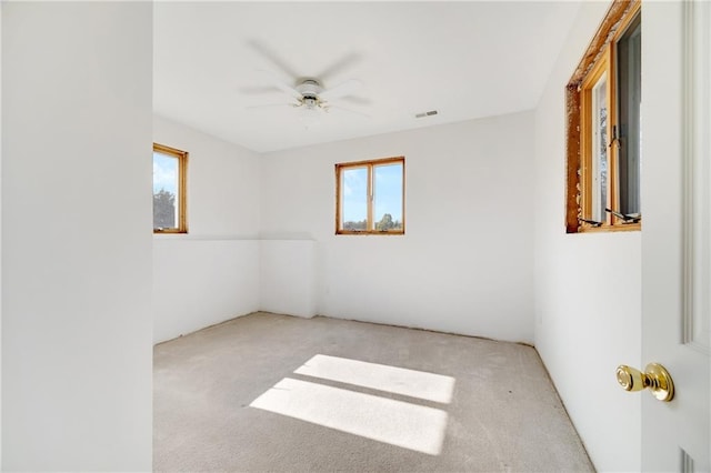 empty room featuring light carpet and ceiling fan