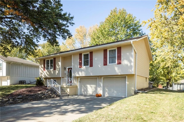 raised ranch with a front lawn and a garage