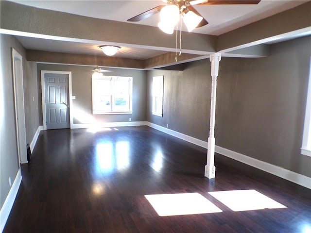 spare room with dark wood-type flooring and ceiling fan