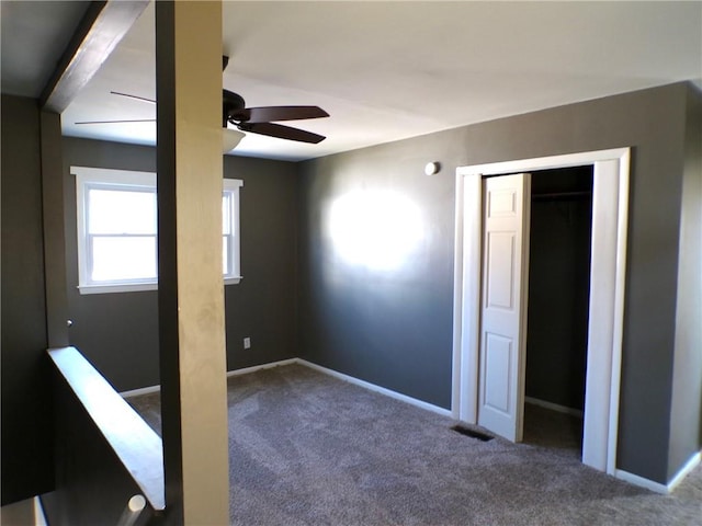 spare room featuring carpet floors and ceiling fan