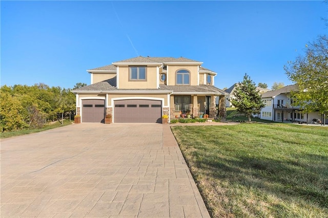 view of front of home with a front lawn, covered porch, and a garage