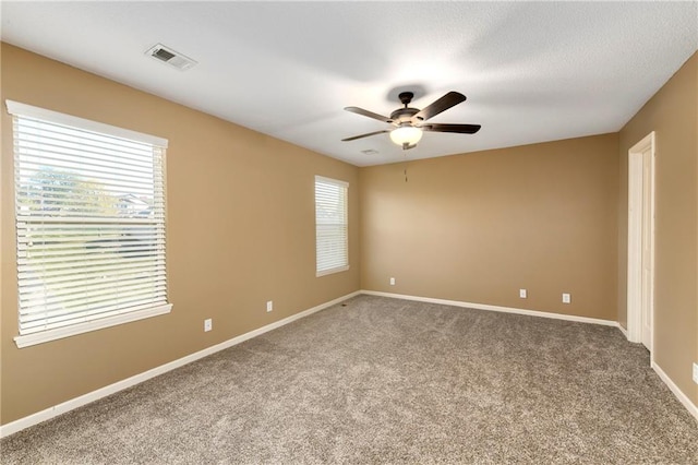 empty room featuring carpet flooring and ceiling fan