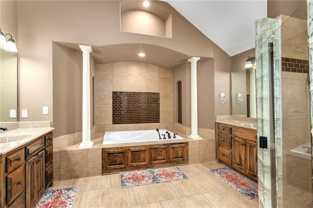 bathroom with lofted ceiling, tile patterned floors, plus walk in shower, decorative columns, and vanity