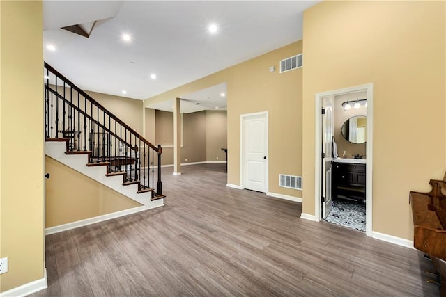 interior space featuring hardwood / wood-style floors and a high ceiling