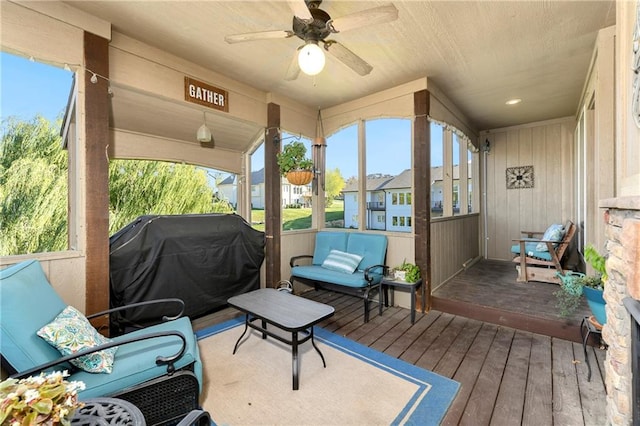 sunroom / solarium featuring ceiling fan