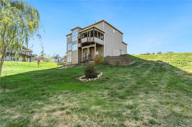 rear view of house with a yard