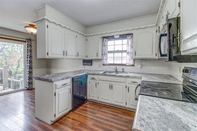 kitchen featuring sink, black appliances, white cabinets, and dark hardwood / wood-style floors