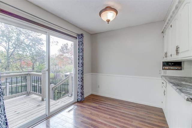 unfurnished dining area with wood-type flooring