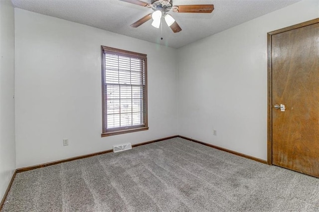 unfurnished room featuring light carpet, a textured ceiling, and ceiling fan