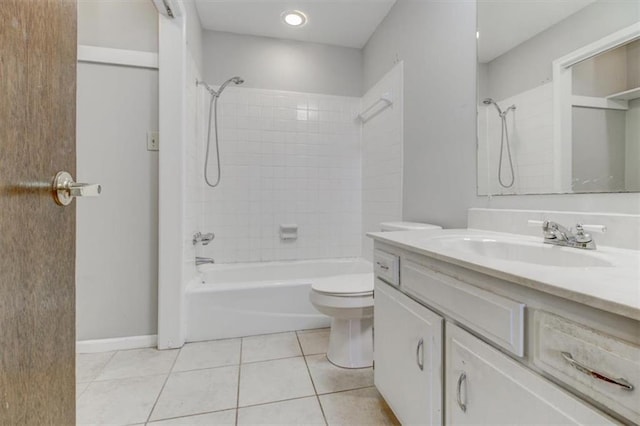 full bathroom with toilet, tiled shower / bath, vanity, and tile patterned floors