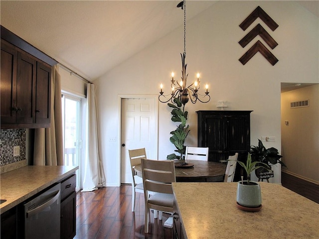 dining area featuring a chandelier, dark hardwood / wood-style floors, and high vaulted ceiling