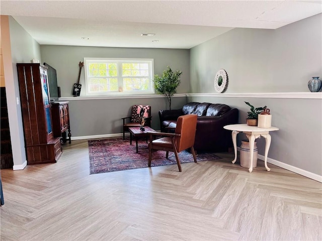 living area featuring light parquet flooring