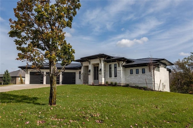 prairie-style house featuring a garage and a front lawn