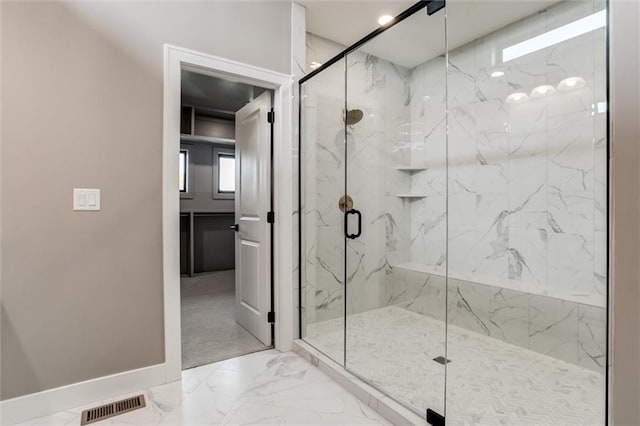 bathroom featuring a shower with door