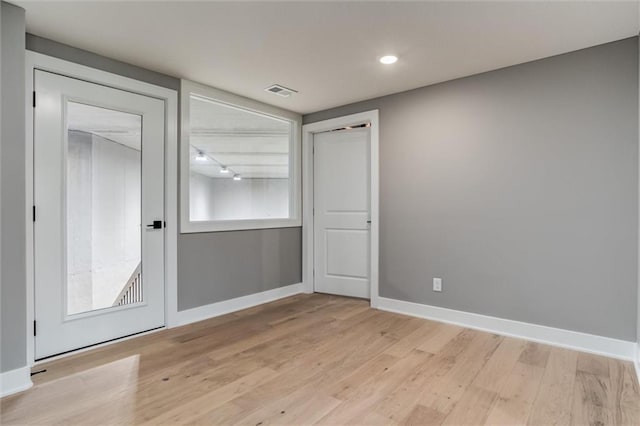 unfurnished room with light wood-type flooring