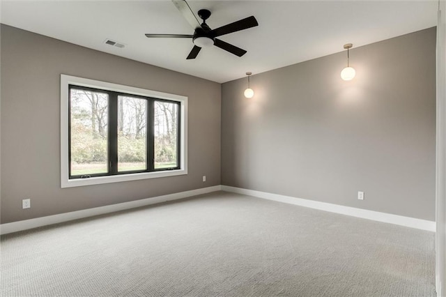 carpeted spare room featuring ceiling fan