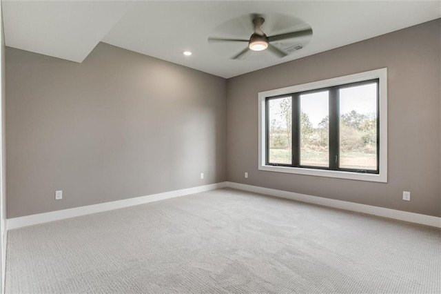 unfurnished room with light colored carpet and ceiling fan