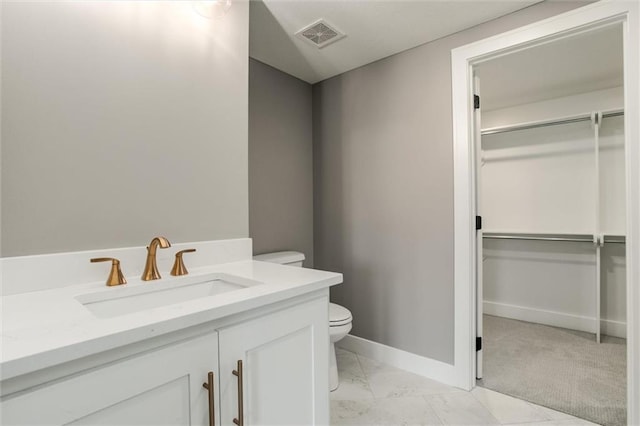 bathroom featuring vanity and toilet