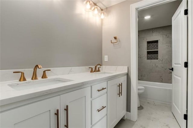 full bathroom featuring toilet, vanity, and tiled shower / bath