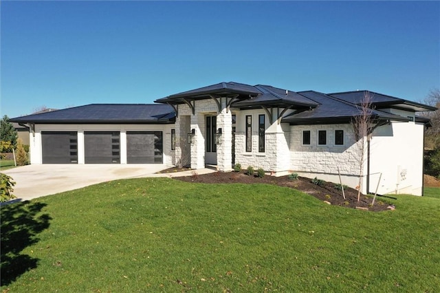 prairie-style house featuring a garage and a front yard