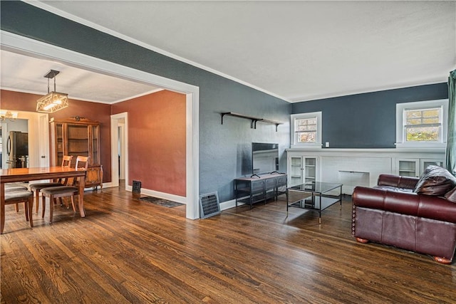 living room featuring crown molding and dark hardwood / wood-style floors