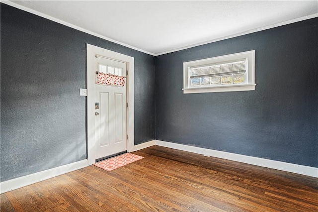 foyer with hardwood / wood-style floors and crown molding