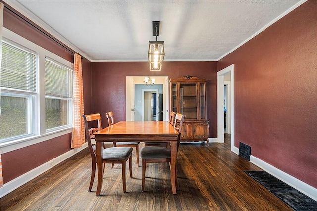 dining area with crown molding, a wealth of natural light, and dark hardwood / wood-style flooring