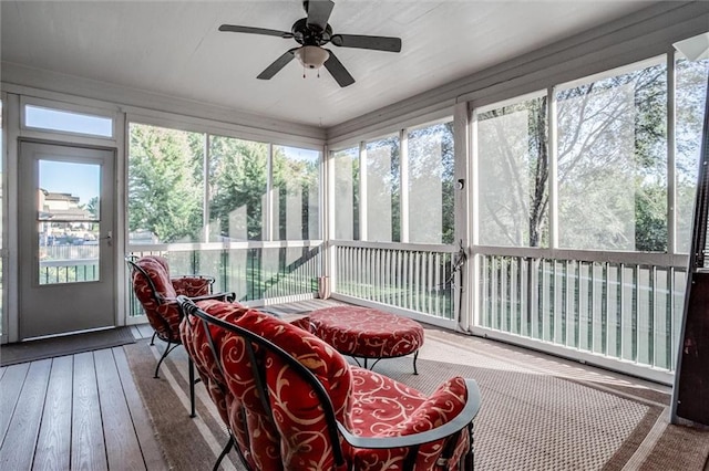 sunroom featuring ceiling fan