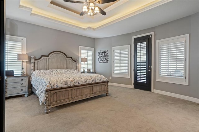 bedroom with carpet flooring, access to outside, ceiling fan, and a raised ceiling