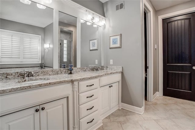 bathroom featuring tile patterned flooring and vanity