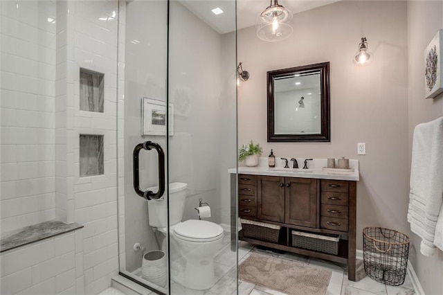 bathroom featuring an enclosed shower, vanity, and toilet