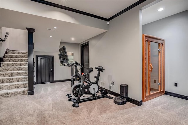 exercise room with light carpet and ornamental molding