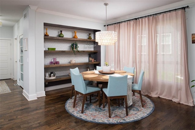 dining area featuring a chandelier and dark hardwood / wood-style flooring