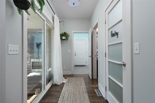 hallway with dark hardwood / wood-style floors