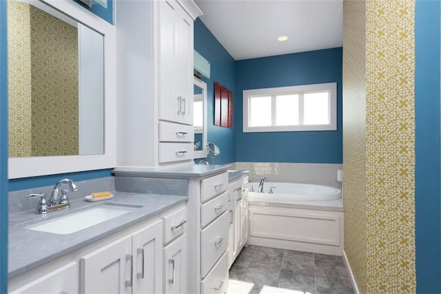 bathroom with vanity, a bath, and tile patterned floors