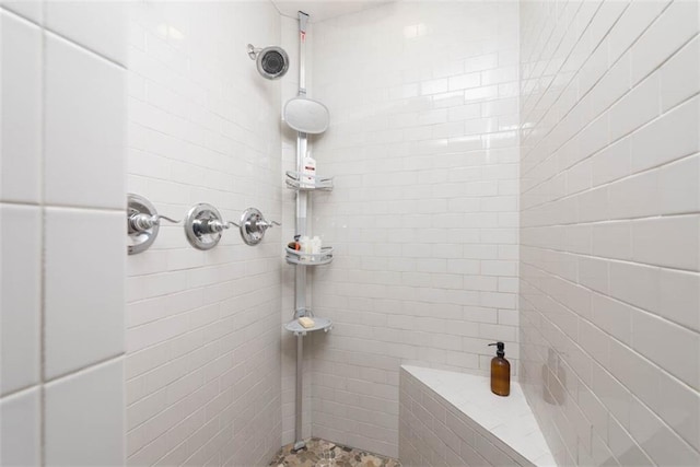 bathroom with a tile shower