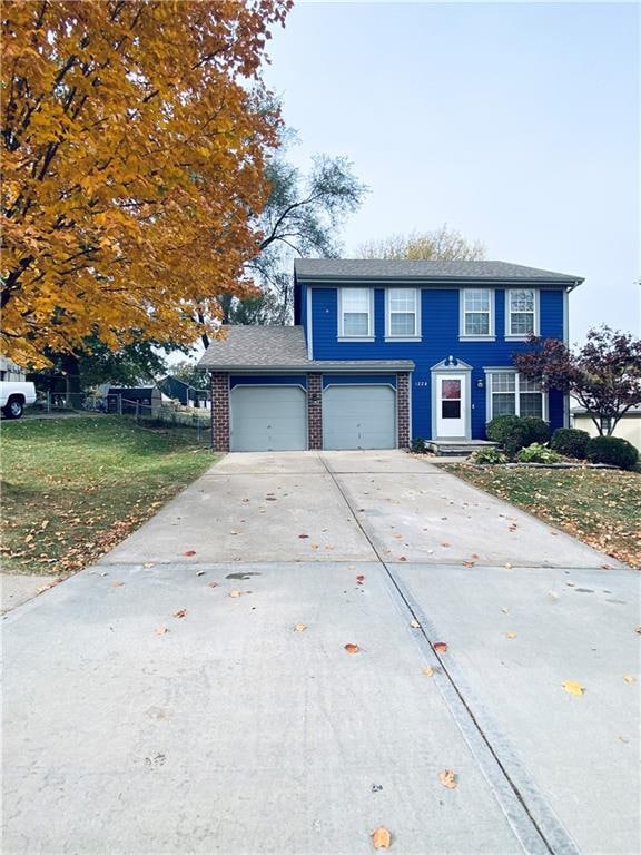 view of front of house with a front yard and a garage