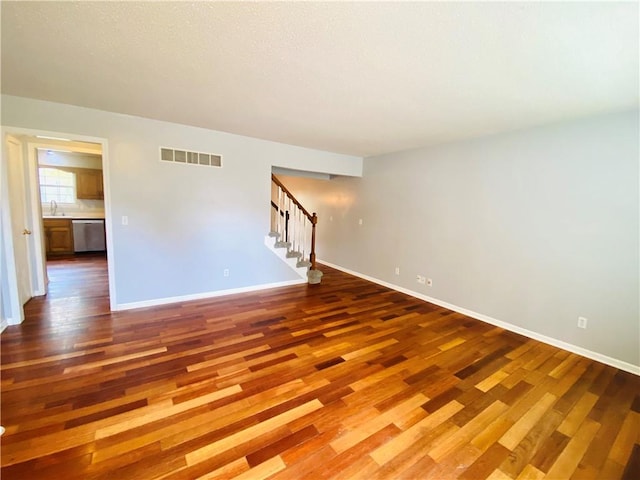 spare room with sink and hardwood / wood-style floors