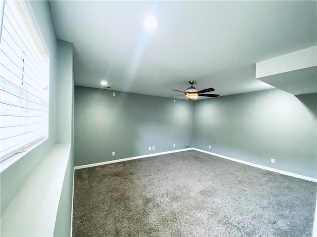 carpeted spare room with ceiling fan